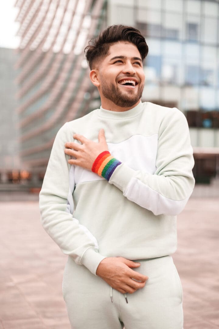 portrait of young hispanic man with lgbt bracelet portrait of young hispanic man with lgbt bracelet